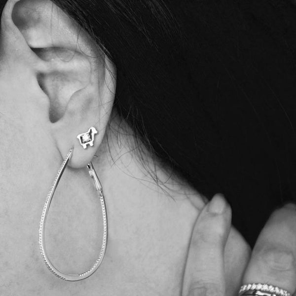 Mini sheep diamond stud earrings on ear