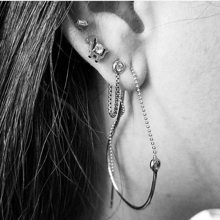 earrings with diamonds and lamb logo