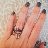 stackable rings on model finger with diamonds