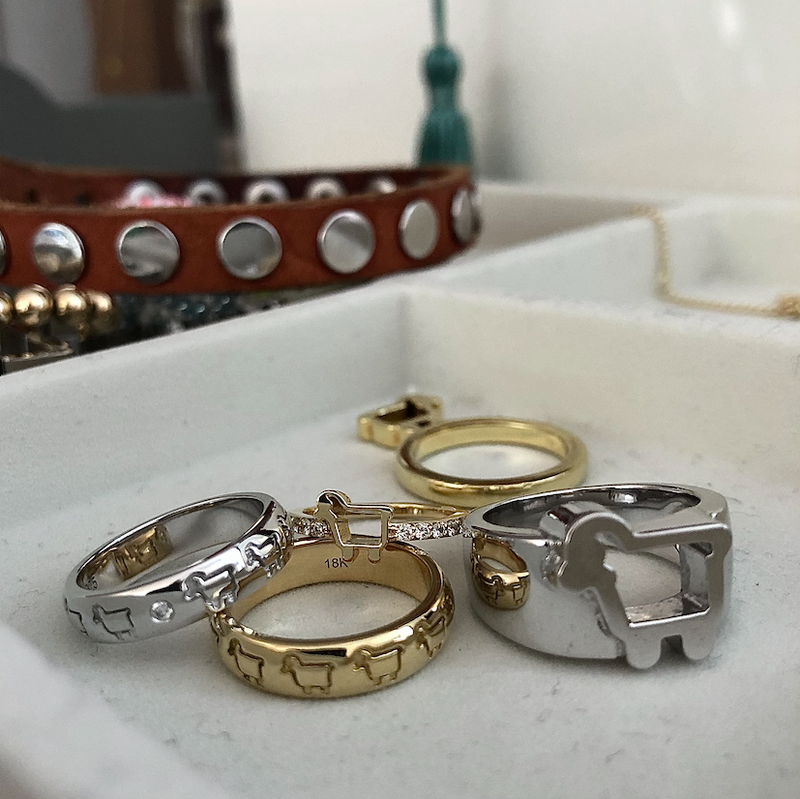 Collection of signature lamb logo rings in sterling silver and 18K gold
