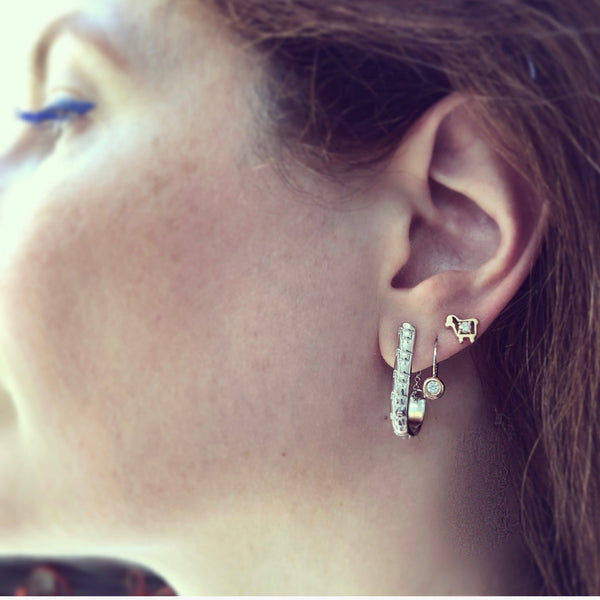 Hoop earrings with signature lamb logo on model