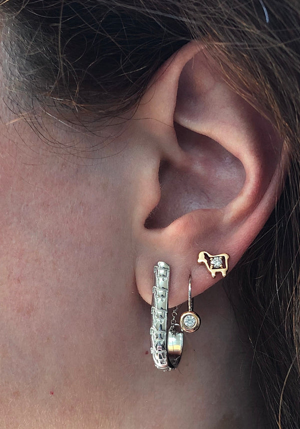 Mini lamb logo stud earring with diamond  shown on ear
