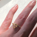 14K gold lamb logo charm ring shown worn on finger