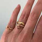 Signature lamb logo rings in 14K  yellow gold shown on finger